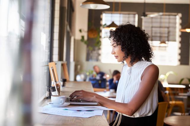 Woman setting up Facebook ads on her laptop